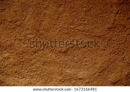 Wall of soil house. texture of clay house structure. Mud background and dark tone, selective focus.