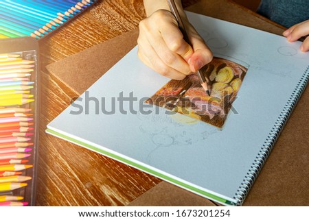 Woman’s hand coloring her picture with pencilcolor. Pencilcolor hand drawing.