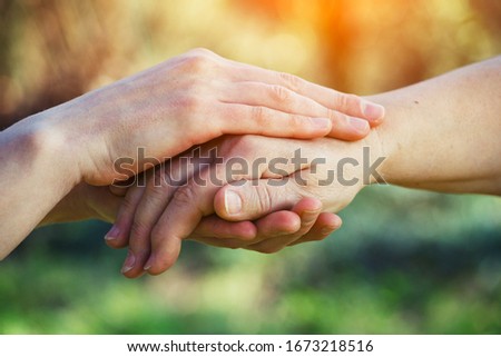 helping hands for aged people, rehabilitation, hospice and nursing home care, service, elderly people care concept, young female hands holding wrinkled hand of senior woman Royalty-Free Stock Photo #1673218516