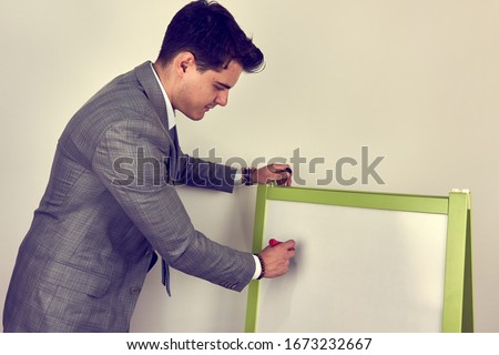 Young man writing on whiteboard
