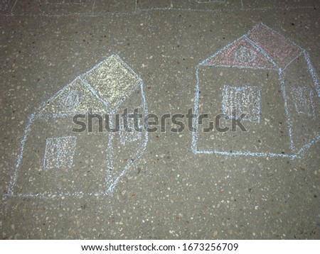 children drawings on the asphalt with colored crayons: houses, fir trees, tourist tents                              