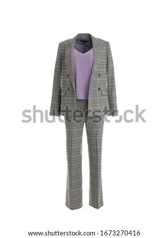 Elegant grey suit and tank top on mannequin against white background. Women's clothes