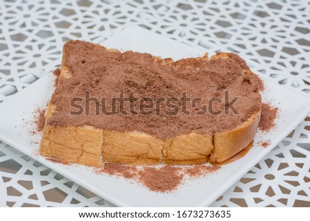 Cocoa powder, applied on bread