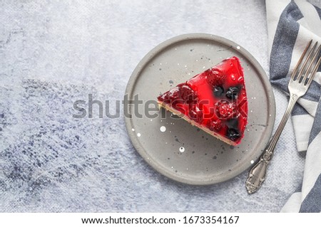 A piece of cake on the grey plate for teatime. Grey background. 