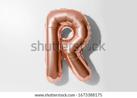 Letter R, Rose gold foil balloon alphabet isolated on a white background with Clipping Path