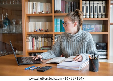 Young caucasian girl studying for university at home with online courses during the coronavirus quarantine. Distance education concept