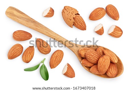 Almonds nuts with leaves in wooden spoon isolated on white background with clipping path and full depth of field. Top view. Flat lay.