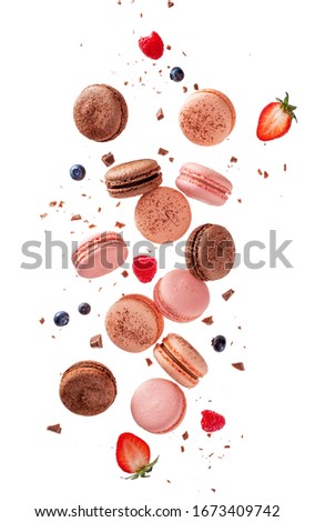 Fly french macarons. Levitate composition with different types colorful macaroons in motion falling or flying isolated on white background