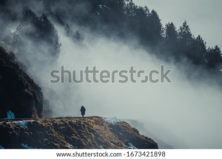 Day in the mountains with sunrise, waterfall and fog