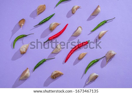 Garlic and red and green chili peppers, pattern. The concept of a vegan diet and virus protection.