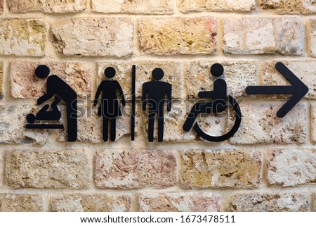 Design pointer to the women and men toilets with an arrow