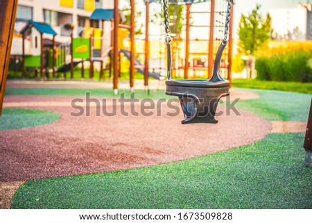  Modern playground on yard in the park near block of flats. Child concept.