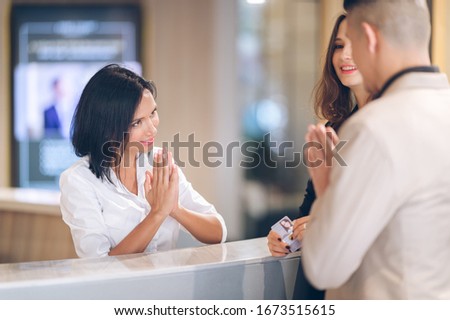 receptionist at counter area,Tourist register in hotel