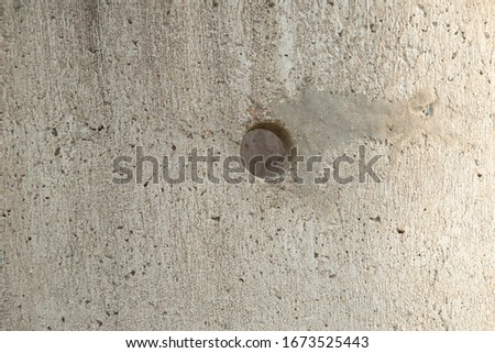 gray concrete slab with round hole closeup