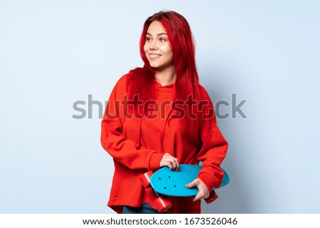 Teenager skater girl isolated on white background happy and smiling