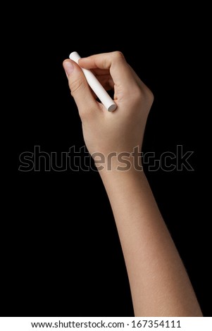 female teen hand with chalk to write something, isolated on black