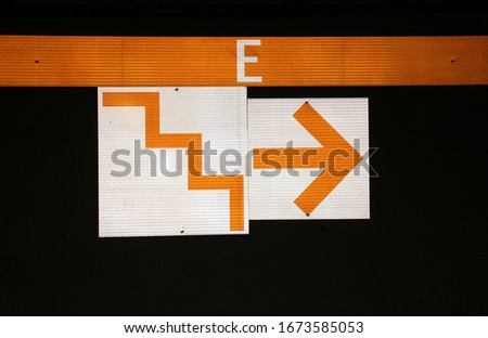 Abstract shots of parking garage interior with white and yellow stripes, arrows, signs, and symbols