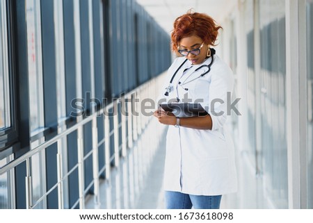 portrait of pretty african medical doctor. african american doctor in modern clinic