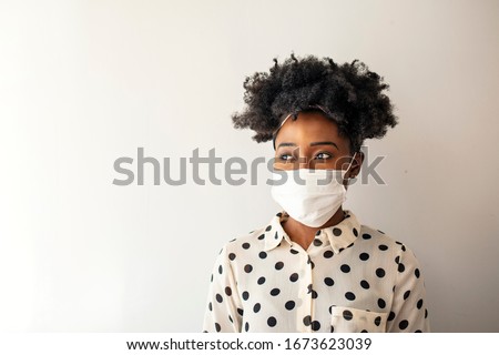 Masked woman - protection against influenza virus. African - American woman wearing mask for protect. Woman wear with protective face mask at home. Stop the virus and epidemic diseases. Royalty-Free Stock Photo #1673623039