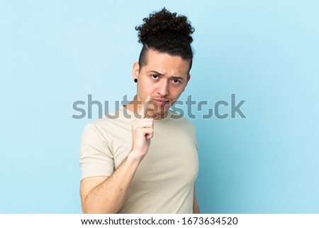 Caucasian man over isolated background frustrated and pointing to the front