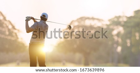 Golfer he's golfing in sunlight of the morning. View from the back. Royalty-Free Stock Photo #1673639896
