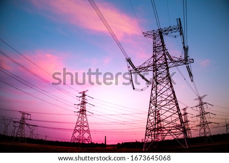 High voltage power cord. Sub-station. High voltage transmission tower. A distribution substation with power lines and transformers. Royalty-Free Stock Photo #1673645068