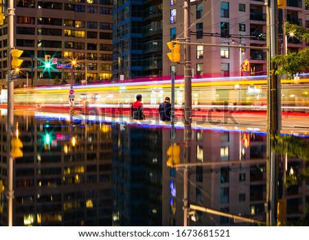 Long exposure shot of people crossing the street in the city