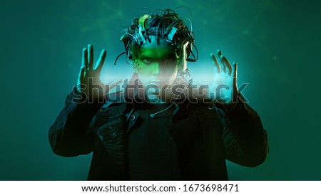 Cyborg. Biological human robot with wires implanted in the head  is holding a light beam. Technologies of the future.