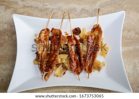 Teriyaki chicken sticks served on top of fried wonton strips.