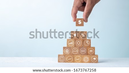 Wooden block with white finance business icons, Financial success concept