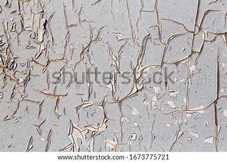 Old paint background. Texture and pattern of peeling dried old paint on the wall. Old painted wall background.