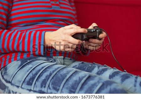 Midsectiom of young woman playing video games