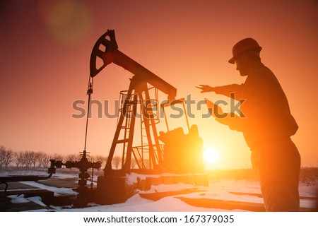 Oil Drill, field pump jack silhouette with setting sun and worker. Lens Flare. See more images and video Refinery, exploration, oil and gas industry