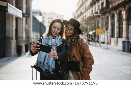  tourists take selfie photos on mobile phone. Travelers using smartphone, hipster travels in Barcelona. Holiday friendship concept. online technology