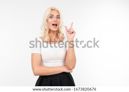 charming girl in a white T-shirt shows her fingers a place for a poster with copy space