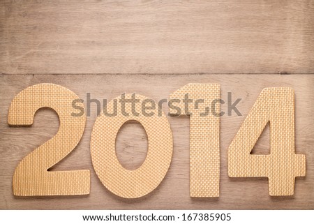 Greeting New Year card with 2014 date on old wood background