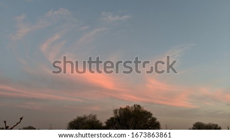 Golden and lite dark clouds and evening time in the sky. Beautiful sunset landscape.
