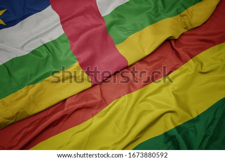 waving colorful flag of bolivia and national flag of central african republic. macro