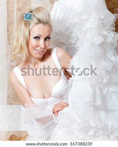 The girl with a wedding dress in hands 