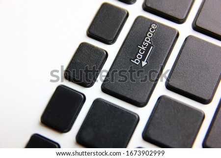 white letter backspace black laptop button .return operation button on note book on white background.