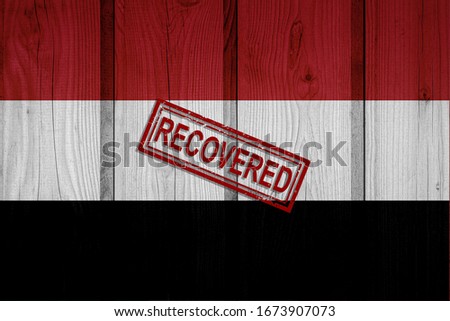 flag of Yemen that survived or recovered from the infections of corona virus epidemic or coronavirus. Grunge flag with stamp Recovered