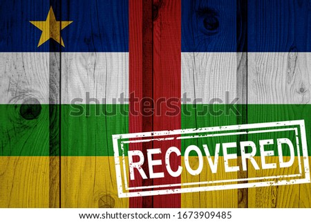 flag of Central African Republic that survived or recovered from the infections of corona virus epidemic or coronavirus. Grunge flag with stamp Recovered