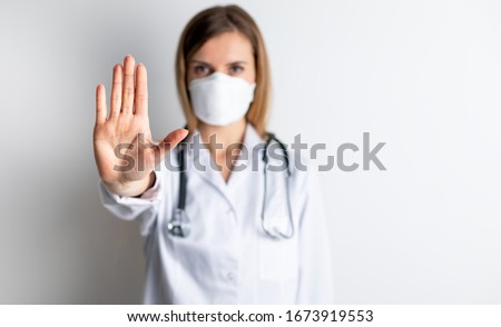 Virus mask female doctor wearing face protection in prevention for coronavirus showing gesture Stop Infection Royalty-Free Stock Photo #1673919553