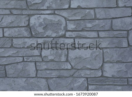 Fragment of a cement wall surface with imitation stone, handmade. Good background for your creative project.