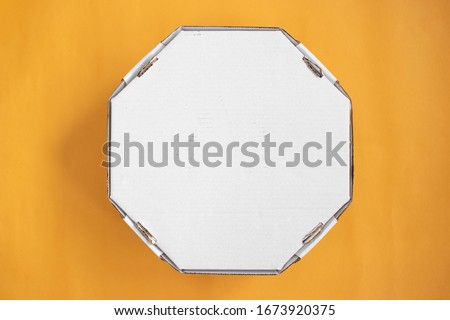 Top view of a pizza box on an orange background Royalty-Free Stock Photo #1673920375