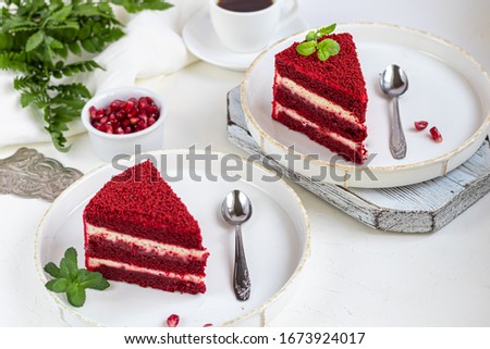 Cake Red velvet on two white plates, two servings. On a light background. Birthday, holidays, sweets.