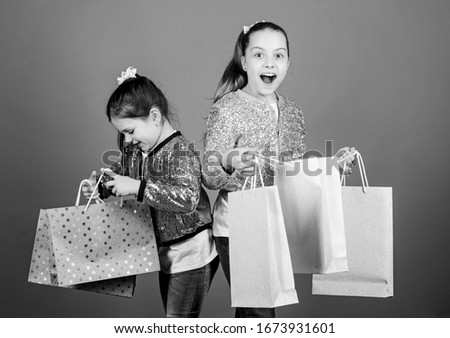 Black friday. Sale and discount. Shopping day. Children bunch packages. Kids fashion. Girls sisters friends with shopping bags violet background. Because image is everything. Shopping and purchase.
