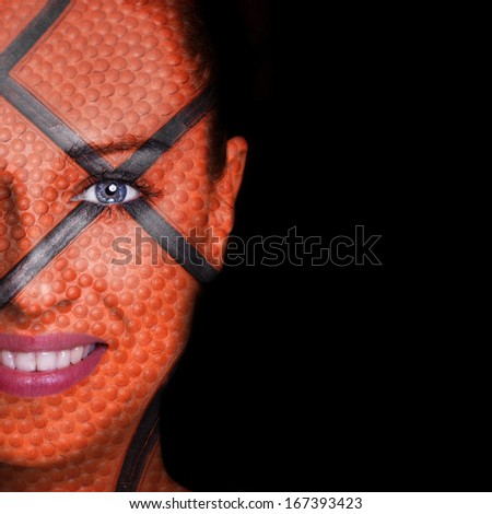 Basketball pattern painted on smiling woman face 