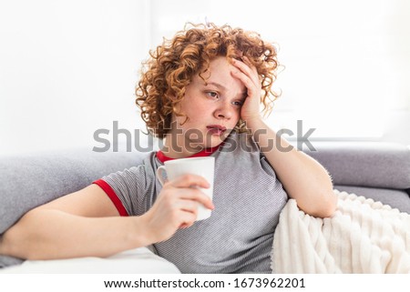 Young Woman Caught Cold Or Flu Illness. Portrait Of Unhealthy Girl scared or virus infection. Cold And Flu. Portrait Of Ill Woman Caught Cold
