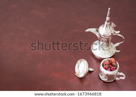 Oriental teapot and tea with dried rosebuds. Ramadan food concept. Revani. With selective focus. Copy space for writing text.